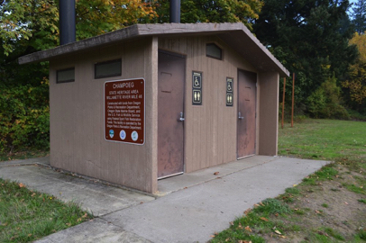 Accessible vault toilets at the boat ramp/group camping area – concrete walkway – state heritage area sign